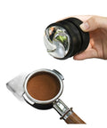 Top Tier Espresso Coffee Distributor And Leveler With Adjustable Depth For 58.35mm Portafilters held above a portafilter with coffee grounds.