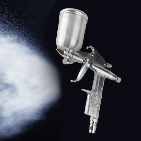 Heavy Duty Professional 0.5mm Mini Pneumatic Spray Gun With Smooth Operator Design And Slick Pro Finish For Auto Bodywork Car Painting And Quick Chip Fixes Total Pro Move, shown spraying a fine mist.