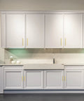 30 Pack 7 3 Eighths Inch Square Cabinet Pulls In Brushed Brass Stainless Steel For Kitchen Drawers And Cabinets, 5 Inch Center To Center Hole Spacing, Durable Modern Handles installed on white kitchen cabinets.
