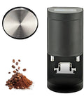 Heavy Duty Electric Coffee Tamper, Auto Sensing Espresso Press With Adjustable Steel Stand And Kickproof Base For Smooth Daily Grinds, slick black finish with stainless steel head and coffee grounds.