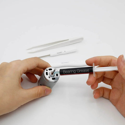 Applying Pro Grade High Performance Spindle Lubricant Oil And Bearing Grease for PC fans and motors using a syringe applicator.