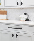 Knockout Matte Black Square Cabinet Pulls Single Hole Kitchen Drawer And Door Hardware 30 Pack shown on kitchen drawers.