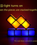Stackable Night Light With Seven Color LED Glow Interlocking 3D Tangram Puzzle Blocks illuminating in dark room.
