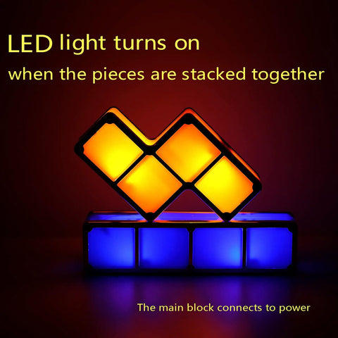 Stackable Night Light With Seven Color LED Glow Interlocking 3D Tangram Puzzle Blocks illuminating in dark room.