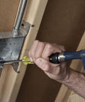 Man using Demolition And Phillips Screwdriver Set With Plated Strike Cap And Heat Treated Blades for heavy duty chiseling work