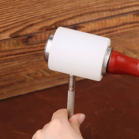 Leather Craft Tools Kit With 20 Leather Stamping Tools, Leather Hammer shown in action on a piece of leather in a workshop setting