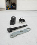 Heavy Duty Trailer Lock Bolt And Hitch Pin Replacement For Bike Racks Anti Theft Security Fastener With Keys And Wrench Plate components laid out on concrete
