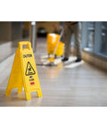 Heavy Duty Real Deal Built Tough Two Sided Caution Wet Floor Sign Stomp Out Slip Hazards In restaurants with a mop.