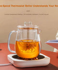 Smart Desk Electric Coffee Mug Warmer With Three Adjustable Heat Settings And Twelve Hour Auto Shut Off featuring a glass tea pot on a white base.