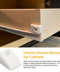 Close-up of 15 Piece Plastic Cabinet Drawer Slide Bumpers And Screws on a wooden drawer edge for noise dampening.