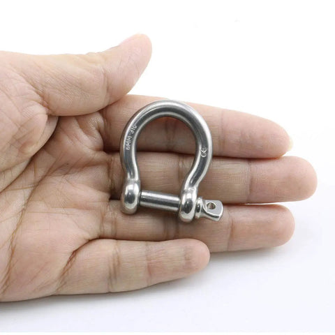 Badass Heavy Duty Bow Shape Screw Pin Anchor Shackle One Quarter Inch 304 Stainless Steel Four Pack in hand, showcasing size.