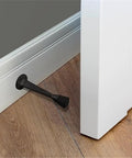 10 Pack Stainless Steel Cast Door Stops 3 Inch Matte Black Finish With White Rubber Stopper mounted on wall protecting door