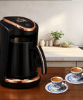 Turkish And Greek Coffee Maker For Home Use 1 To 4 Cup Capacity 400W Electric Pot BPA Free in kitchen setting with cups
