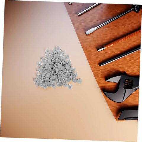 Pile of grey screw cover caps with tools, 500 pack durable plastic thread protectors for cabinets furniture and construction.