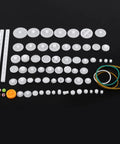 Durable Plastic Gear Kit With Pulleys Belts And Crown Gears For DIY Models And Robotics 75 Varieties Gear Set spread on black surface