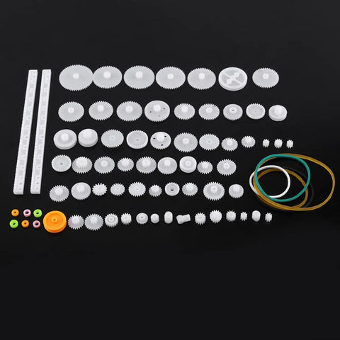 Durable Plastic Gear Kit With Pulleys Belts And Crown Gears For DIY Models And Robotics 75 Varieties Gear Set spread on black surface