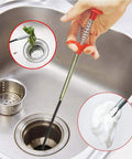 Ultra Slim 79 Inch Drain Snake Tool With Flexible Grabber Claw clearing clog in kitchen sink with debris removal close-up