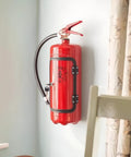 Fire Extinguisher Shaped Liquor Dispenser Mini Metal Bar Accessory installed on wall, designed for whiskey storage and dispensing.