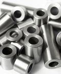 Close-up of steel spacers; round, unthreaded bushings, 1 in OD x 1/2 in ID, 5-pack.