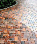 Heavy Duty Wet Look Paver Sealer For Concrete And Brick Blocks on a slick, wet-looking brick driveway.