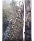 Pipes leading to 50KW Water Turbine Generator With 220V And 400V Output Rugged Outdoor Hydro Power Generator against rocky landscape