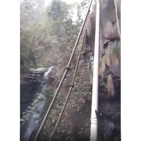 Pipes leading to 50KW Water Turbine Generator With 220V And 400V Output Rugged Outdoor Hydro Power Generator against rocky landscape