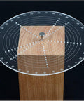 Front view: 8-inch round center finder compass on wood block; clear circular protractor with concentric rings.