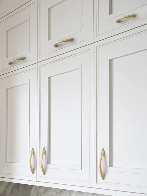 Top Notch 5 Inch Arch Cabinet Pulls Featuring Brushed Gold Zinc Alloy Build on white cabinets, showcasing elegant design and functionality.