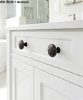 Oil Rubbed Bronze Round Cabinet Knobs 12 Pack 1.4 Inch Diameter Zinc Alloy Hardware For Cabinets Drawers Dressers Kitchen And Bathroom Antique Bronze Finish Durable No Fade Rust installed on white cabinet