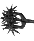 Close-up of Grab And Go All In One Garden Tiller And Scarifier Hand Tool with metal spikes for lawn and soil aeration