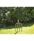 Ergonomic Garden Fork With Four Prongs, 122 Cm Long, Boron Steel, Grey And Black, on grass with bushes in the background