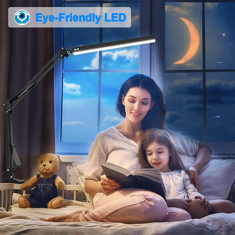 Clamp On LED Desk Lamp For Home And Office in bedroom, illuminating a woman and child reading with moonlit window background.