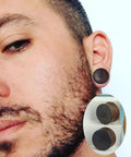 Man wearing Three Pairs Organic Wood Ear Plugs Set With Double Flared Ear Tunnels Saddle Fit Wooden Gauges Five Eighths Inch 16mm