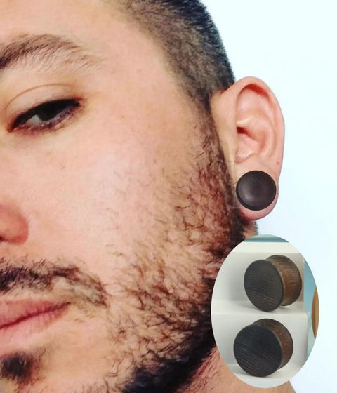 Man wearing Three Pairs Organic Wood Ear Plugs Set With Double Flared Ear Tunnels Saddle Fit Wooden Gauges Five Eighths Inch 16mm