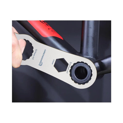 Multi Function Bottom Bracket Wrench Pro Grade Tool For 39 40 Point 5 44mm Outer Diameter 16 Notch Fits Shimano BB Series And SRAM GXP Bikes shown in use on a bike