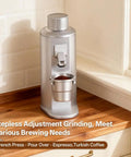Premium Electric Single Dose Coffee Grinder With 63mm CNC Conical Burrs And Stepless Adjustment Anti Static Ground Collection Bin For Smooth As Silk Espresso And Hit The Spot Pour Over Brewing In Matte Black on countertop with ground coffee.
