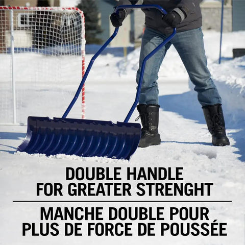 Person using 36 Inch Extra Large Ergonomic Snow Pusher With Steel Handle For Easy Driveway Clearance And Ice Rinks No Fuss Lightweight Yet Durable Snow Shoveling Tool With A Large Two Hand Grip For Maximum Push Power on a snowy driveway.