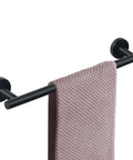 Matte Black 18 Inch Wall Mounted Towel Bar with pink towel, made from rustproof stainless steel for bathrooms and kitchens, 22 lbs capacity