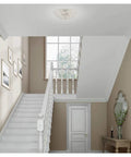 Cassandra 4 Light Brushed Nickel Ceiling Mount Fixture With K9 Crystal Glass illuminating a modern hallway.