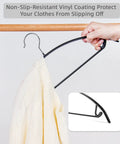 Non Slip PVC Coated Hangers 20 Pack Heavy Duty Coat Suit Jacket Hangers Shoulder Bump Free Clothes Hangers For T Shirts Golf Gear And More Durable Closet Organizers In Black shown holding a sweater.