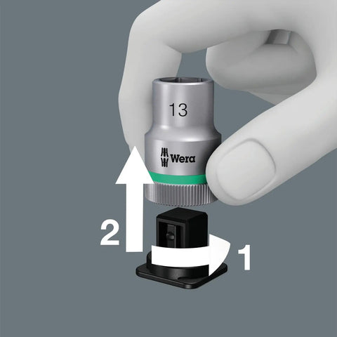 Hand using twist unlock on Zyklop 9-Piece Socket Set On Belt, Three Eighths Inch Drive, demonstrating quick removal and tool attachment.