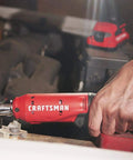 Hand using V20 Cordless 3/8 Inch Ratchet Wrench Bare Tool Only, 300 RPM, Up To 35 Ft-Lbs Torque, LED Work Light on car engine