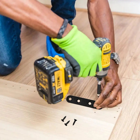 Person installing a 12 Piece Premium Steel Heavy Duty Black Straight Corner Braces With Matching Screws on wood surface.