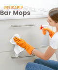 Person cleaning kitchen cabinet with Absorbent Quick Dry Bar Mop Towels Pack Of 60, 14x17 Commercial Grade Cotton Cleaning Rags For Kitchen And Bar, White