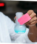 No Sweat Finger Shields Durable Anti Static Pink Latex Covers For Joint Relief And Cracked Skin Repair on hand holding a flask.