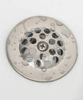 Slick Brushed Nickel Trip Lever Tub Drain Trim Kit Set With Overflow Face Plate Bathtub Drain Strainer And Screws Easy Swap DIY Install To Level Up Your Bathroom Setup Today showing a close-up of the drain cover with water droplets.