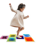 Child playing on Liquid Sensory Floor Tiles Set 11.8 Inch Square Multicolor For Kids Interactive Sensory Play With Floating Objects And Colorful Liquid Swirls No Installation Needed Six Tile Pack