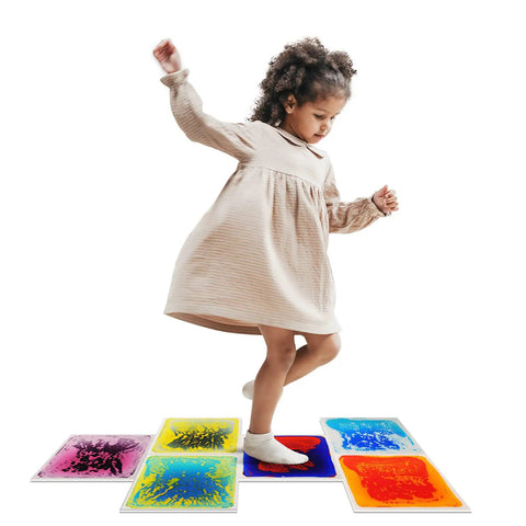 Child playing on Liquid Sensory Floor Tiles Set 11.8 Inch Square Multicolor For Kids Interactive Sensory Play With Floating Objects And Colorful Liquid Swirls No Installation Needed Six Tile Pack