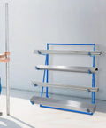 Legit Heavy Duty Steel Cantilever Storage Rack With 440 Lb Capacity Adjustable Arms holding metal pipes for storage in a workshop.