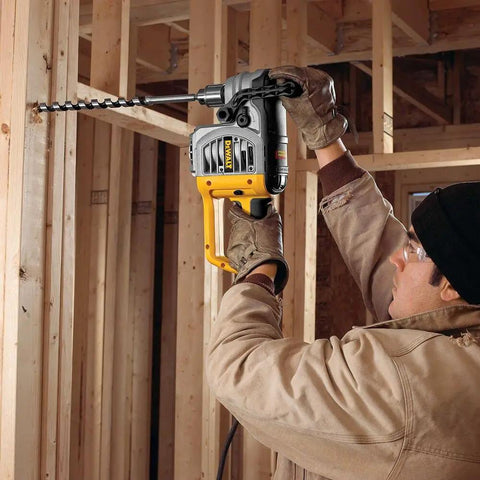 Worker using Ship Auger Drill Bit For Hardwood And Nail Embedded Wood, 1 Inch By 17 Inch, in construction setting